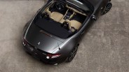 Dark gray Mazda MX-5 convertible with beige leather seats viewed from above on a concrete surface.