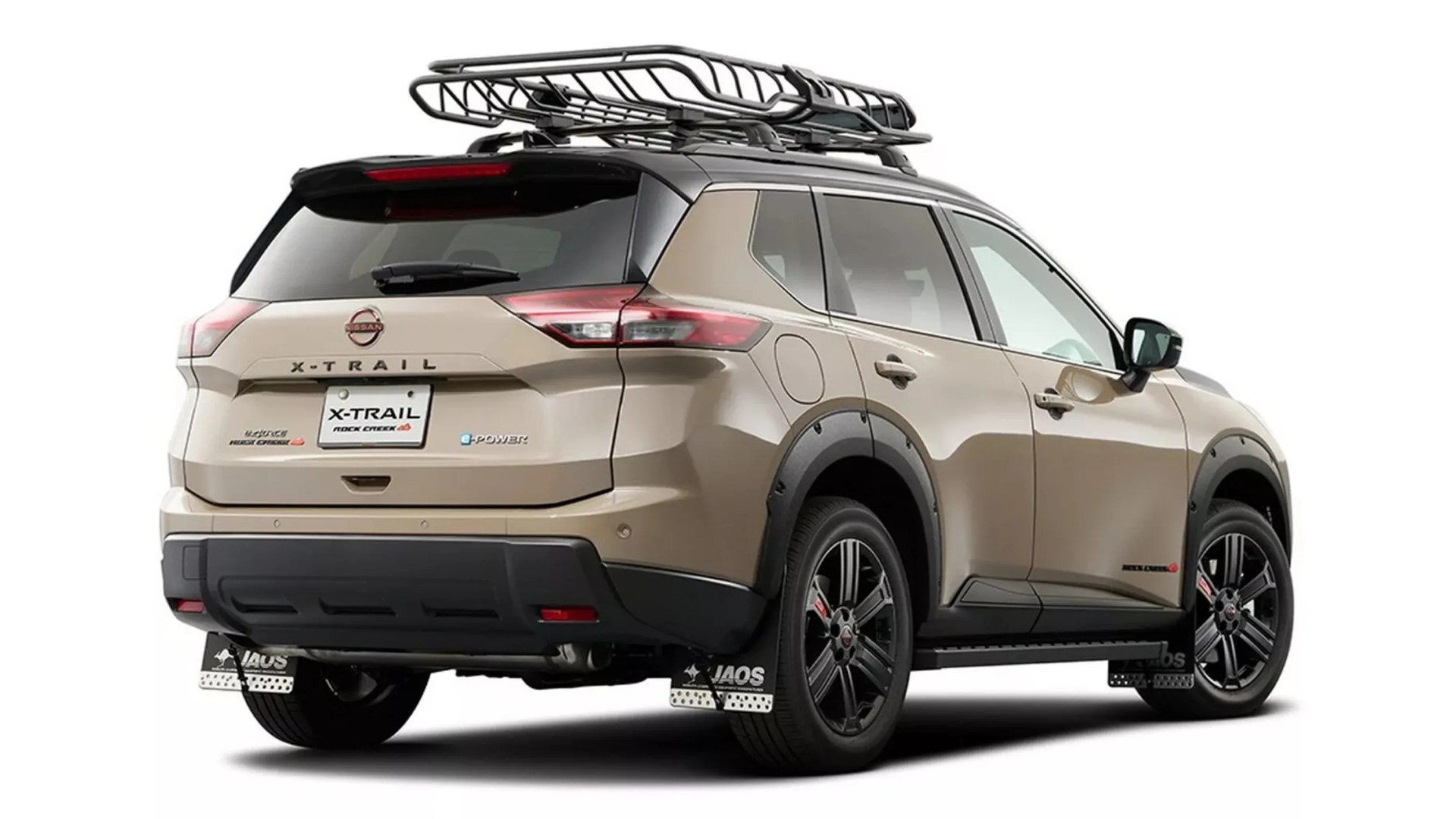 Beige Nissan X-Trail SUV with black roof rack, black wheel arches, and black alloy wheels viewed from rear side.