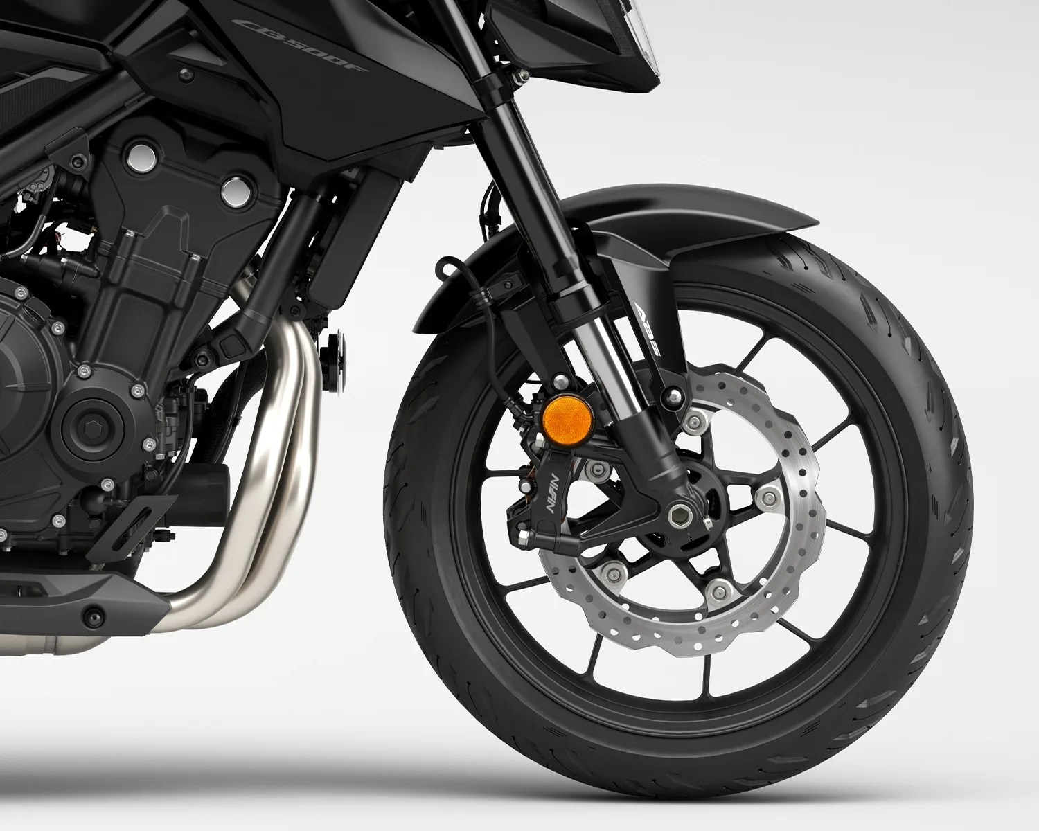 Front wheel and suspension of a black CB500F motorcycle with disc brake and ABS label.