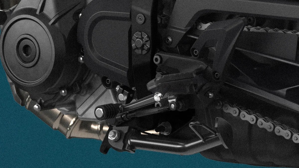 Close-up of a motorcycle's black footpeg, gear shift lever, and part of the chain drive against a teal background.