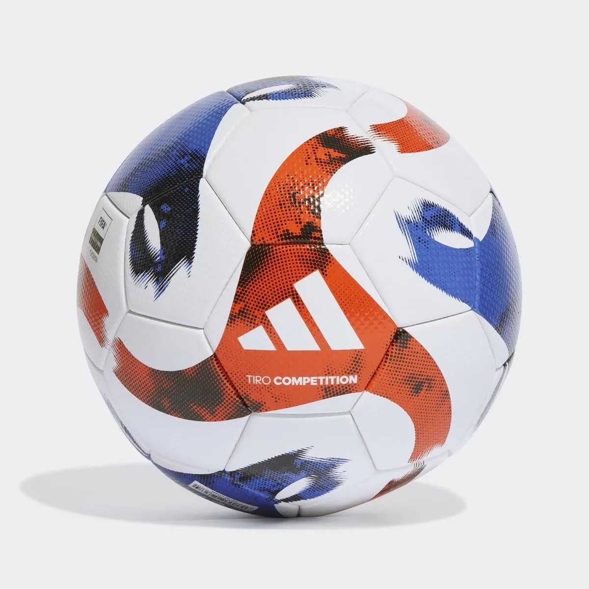 White Adidas Tiro Competition soccer ball with red and blue graphic patterns and logo.