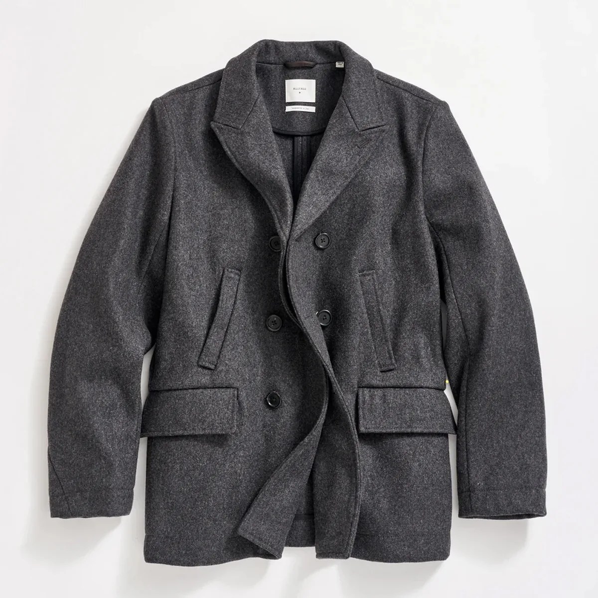 Dark gray wool double-breasted pea coat with notch lapels and flap pockets.