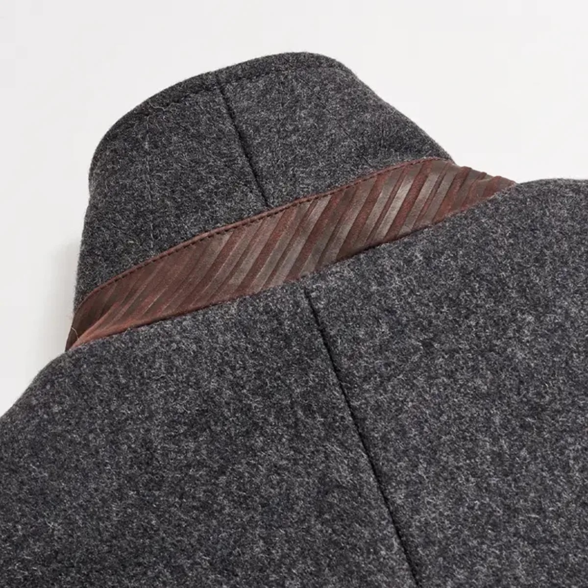 Close-up of a dark gray wool fedora hat with a brown striped ribbon band.