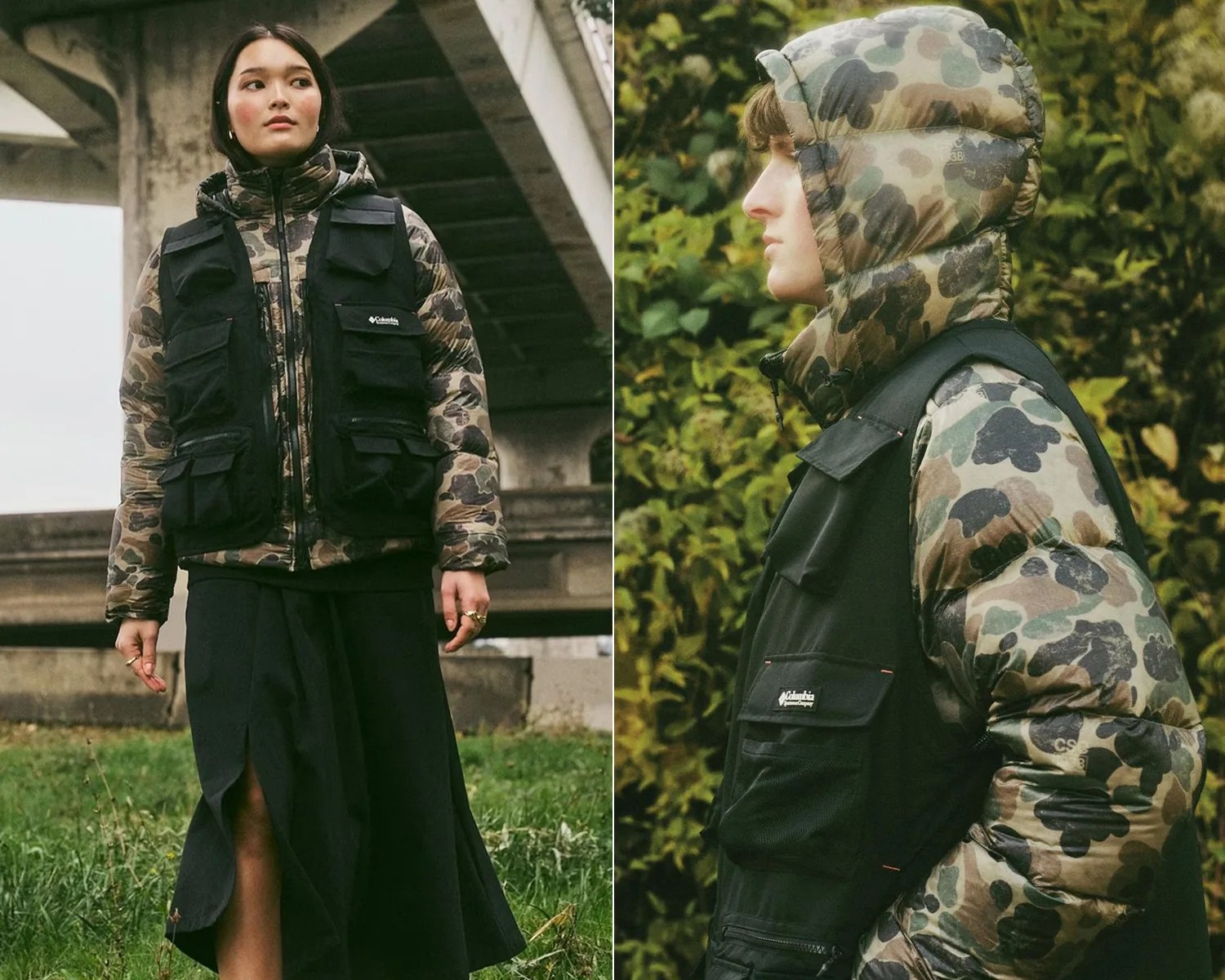Two people wearing black utility vests over camouflage puffer jackets, one standing outdoors under a bridge and the other in profile against greenery.