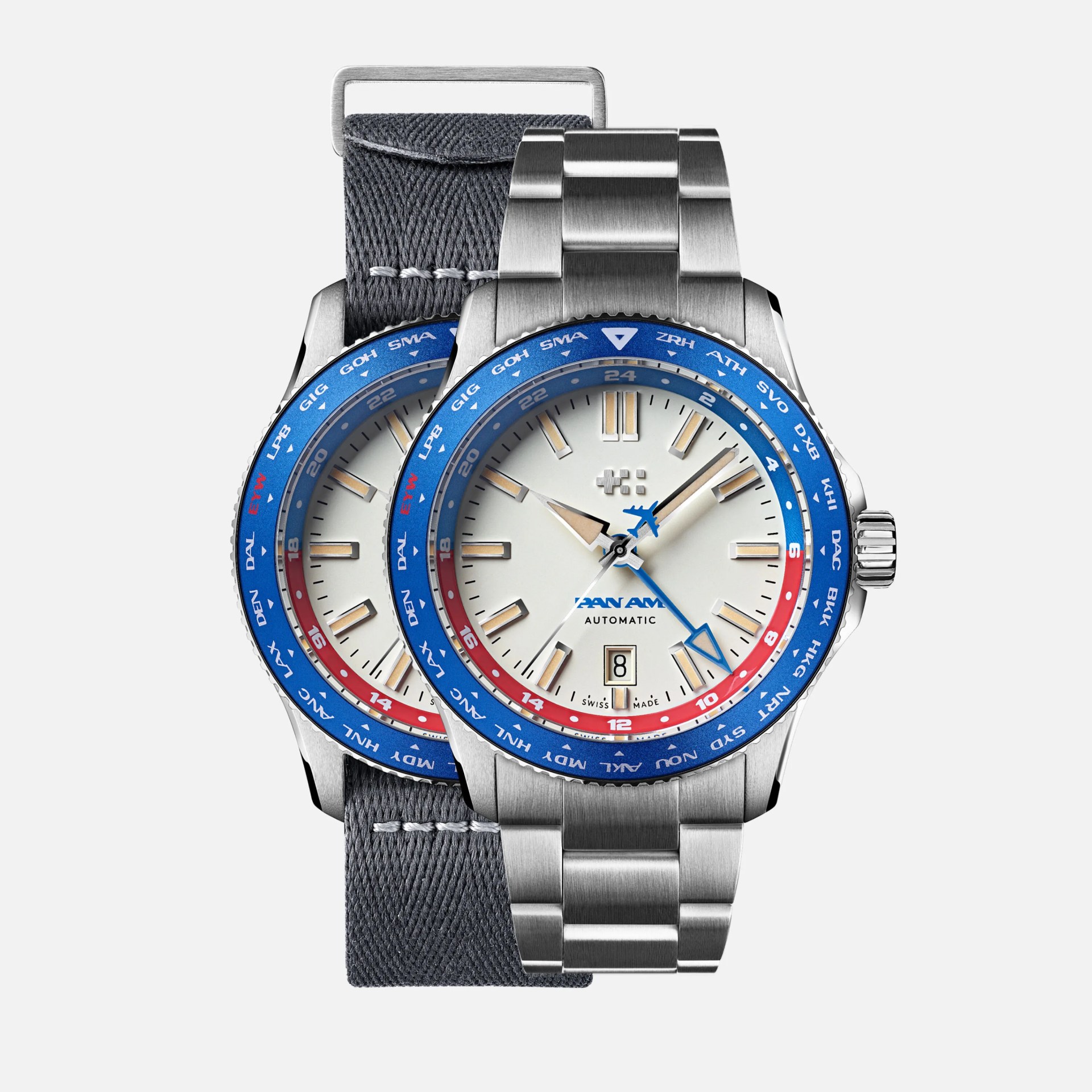 Two Pan Am automatic wristwatches with white dials, blue and red bezels, one with a metal bracelet and one with a gray fabric strap.