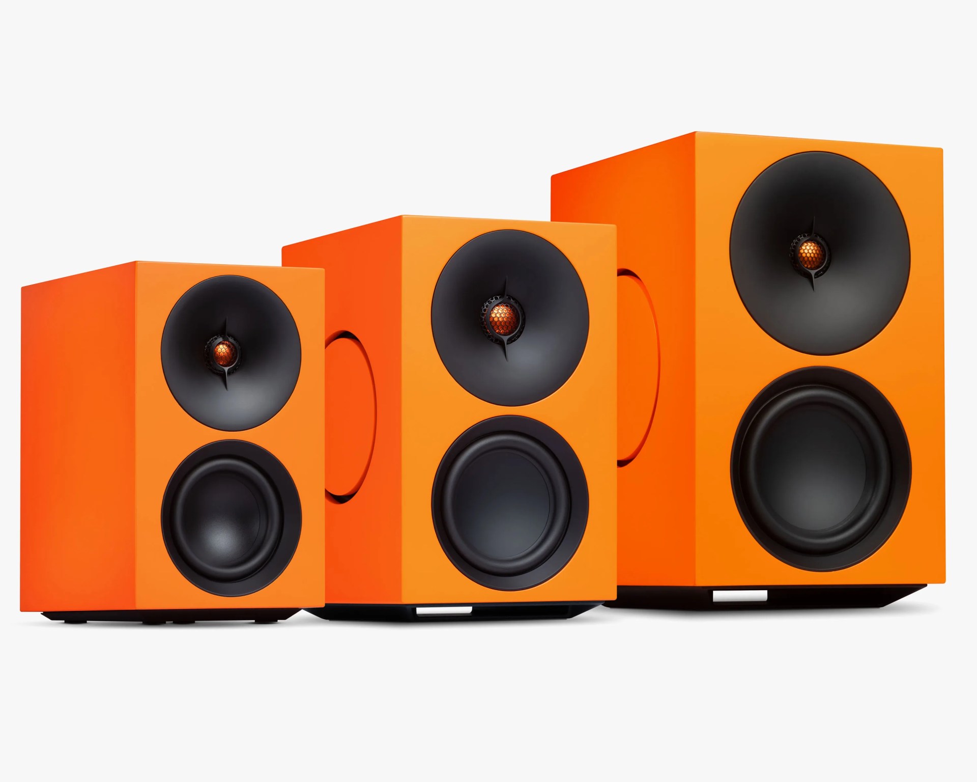 Three orange rectangular speakers of varying sizes with black circular drivers and orange tweeters.
