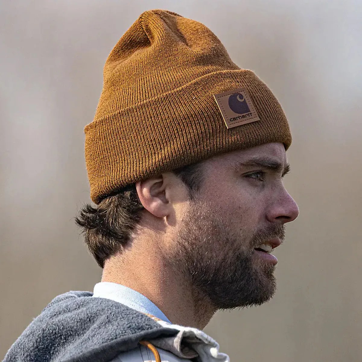 Brown Carhartt knit beanie worn on a man's head in profile.