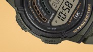 Close-up of a digital watch face showing "10 YEAR BATTERY," "WR 100M," and buttons labeled "ADJUST" and "MODE.