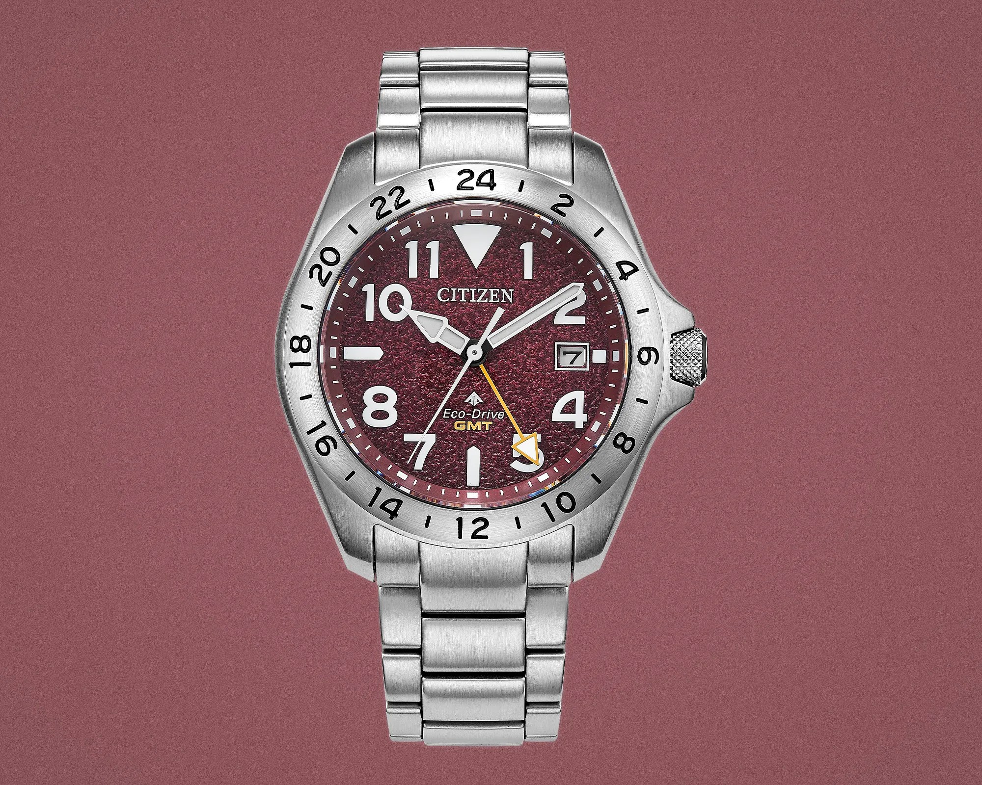 Silver stainless steel Citizen Eco-Drive GMT watch with textured burgundy dial and date window.