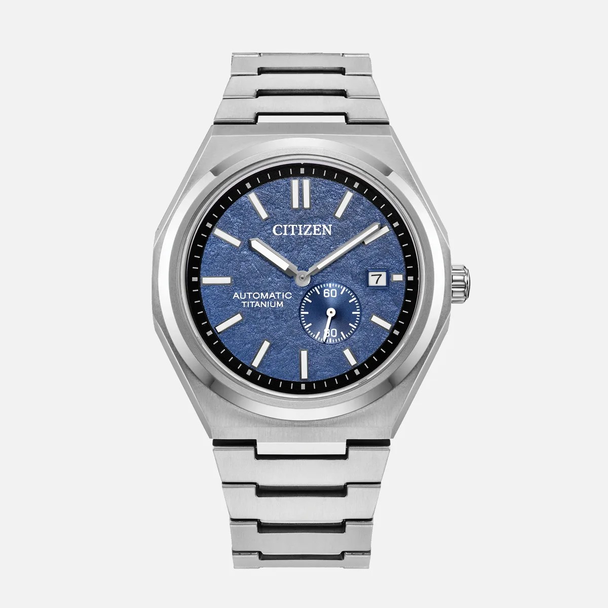 Silver titanium Citizen wristwatch with textured blue dial, date window, and linked metal bracelet.