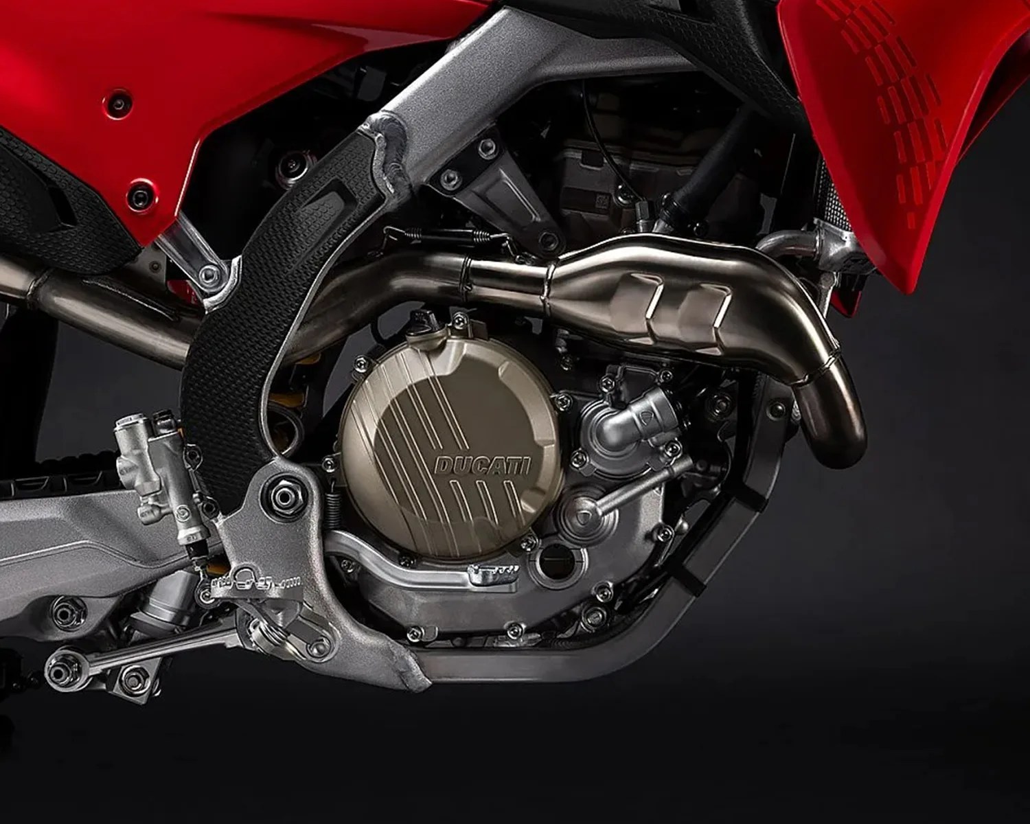 Close-up of a Ducati motorcycle engine with metallic components and red bodywork.