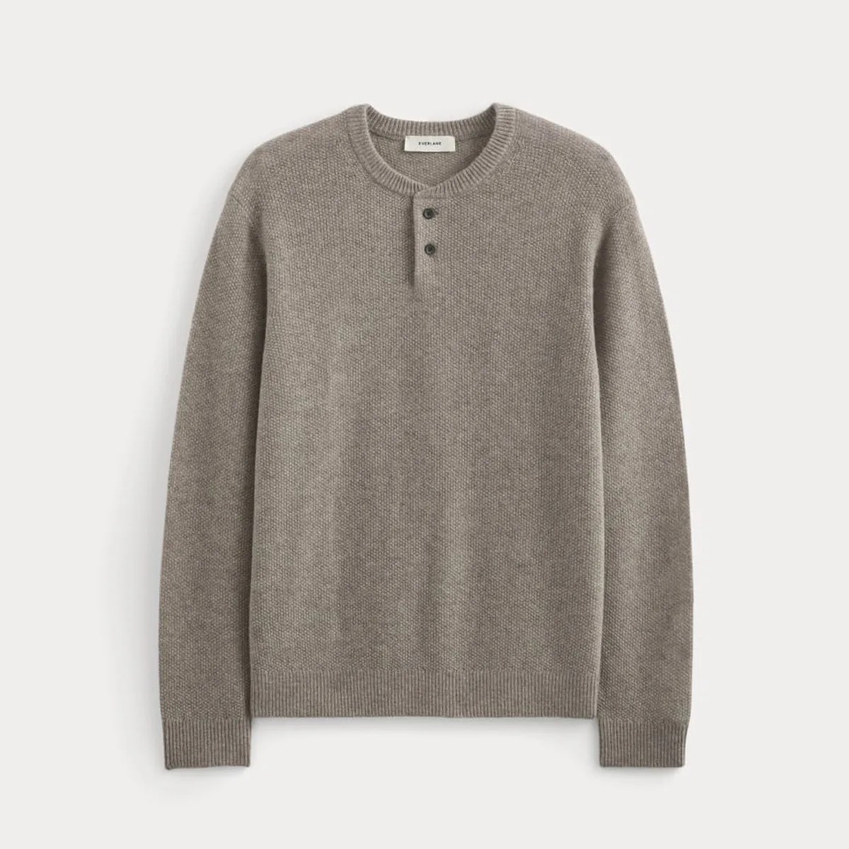 Light brown knit sweater with a round neckline and two buttons on the front placket.