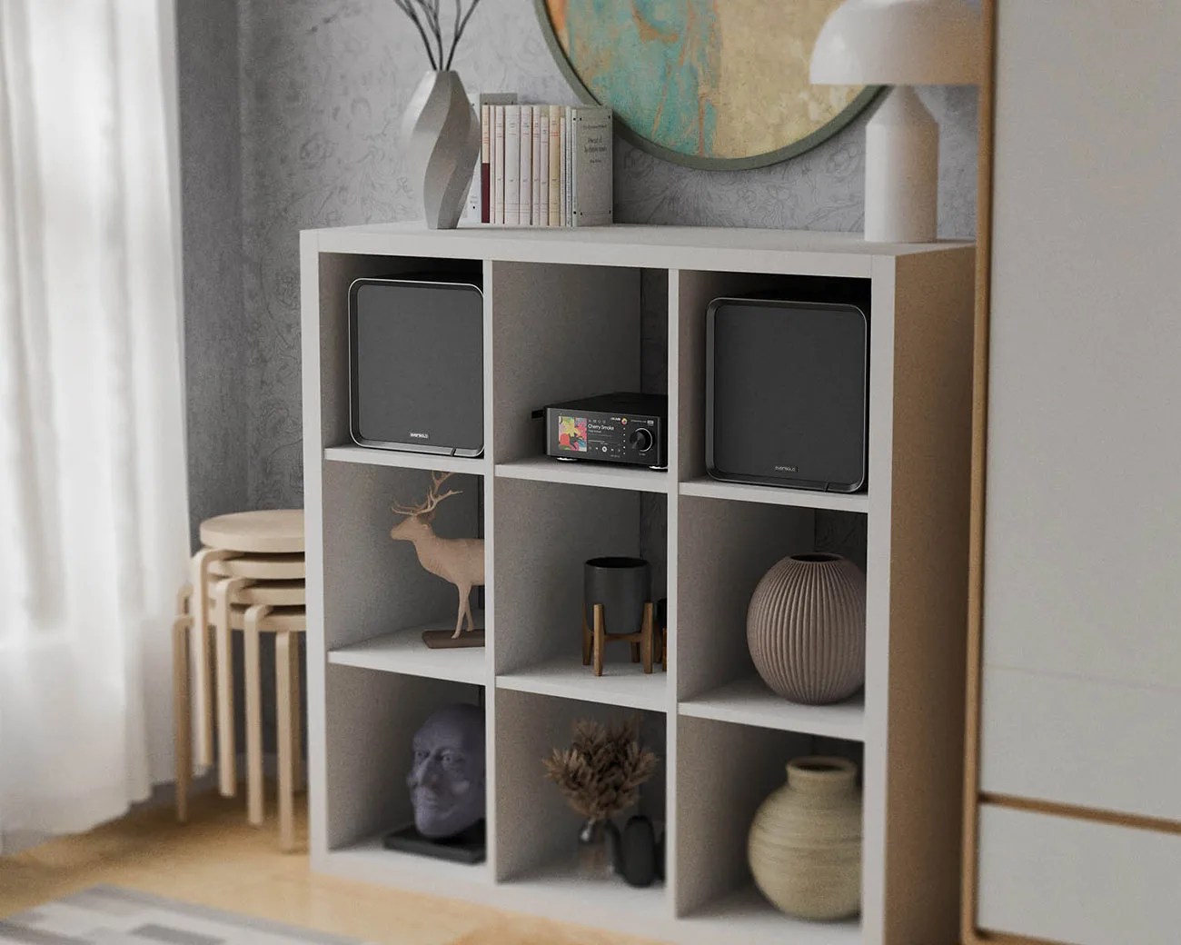 White cubical shelving unit with black speakers, decorative vases, a deer figurine, and a small stereo system.