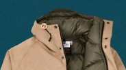Beige jacket with olive-green padded lining and black zipper on a teal background.