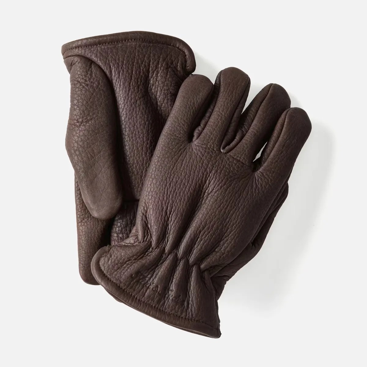 Pair of dark brown textured leather gloves with gathered wrists on a white background.