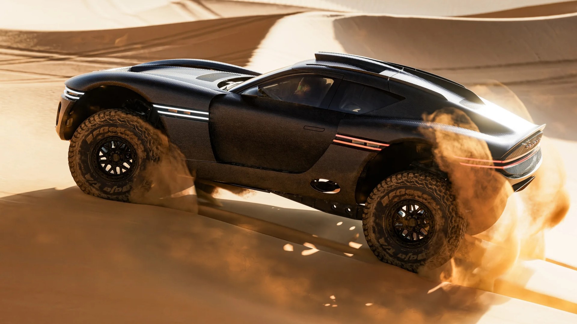 Black off-road sports car with large tires kicking up sand in a desert setting.