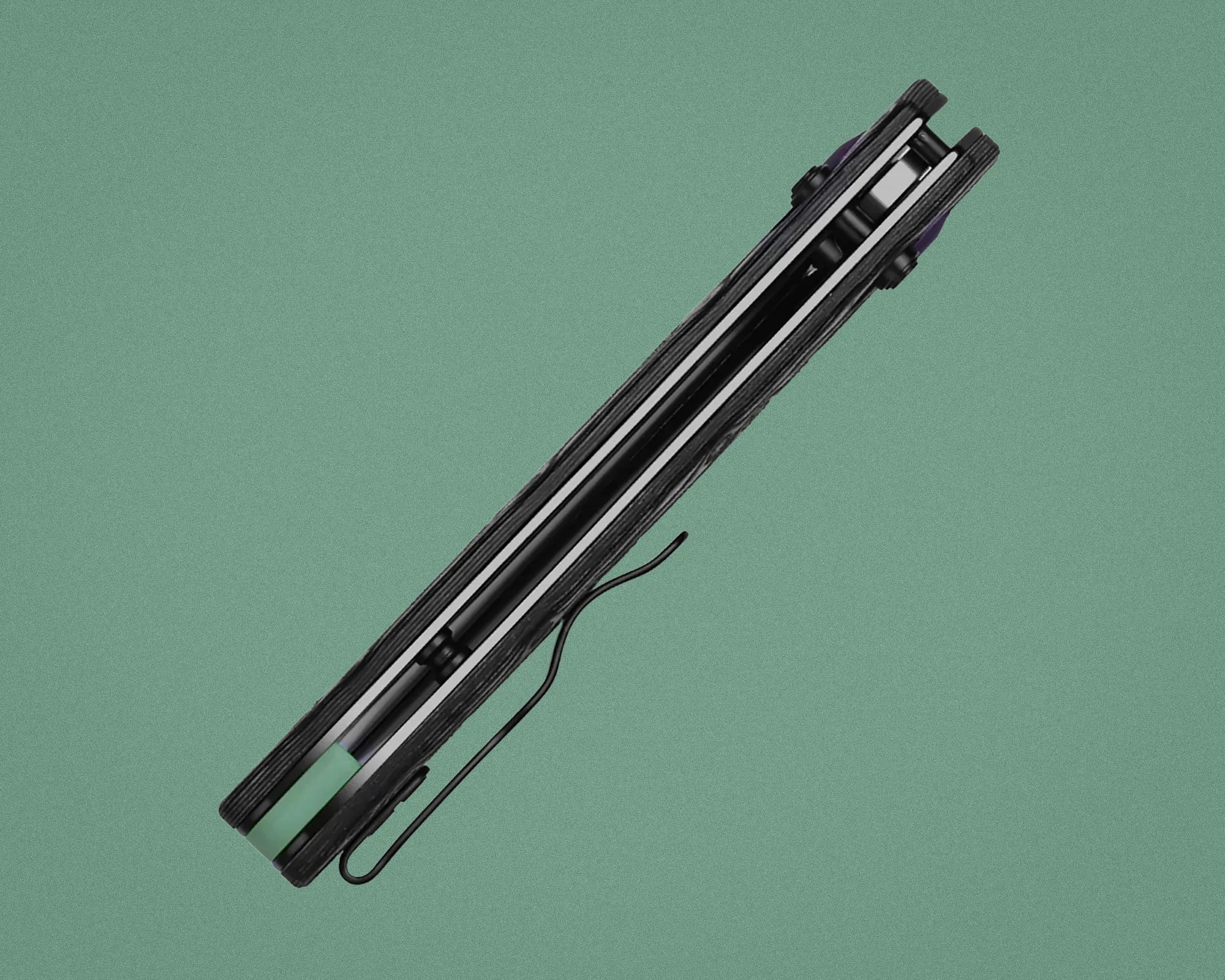 Closed black folding pocket knife with a visible clip and green handle accent on a green background.