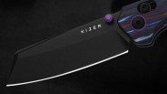 Black Kizer folding knife blade with purple thumb stud and blue and red striped handle.
