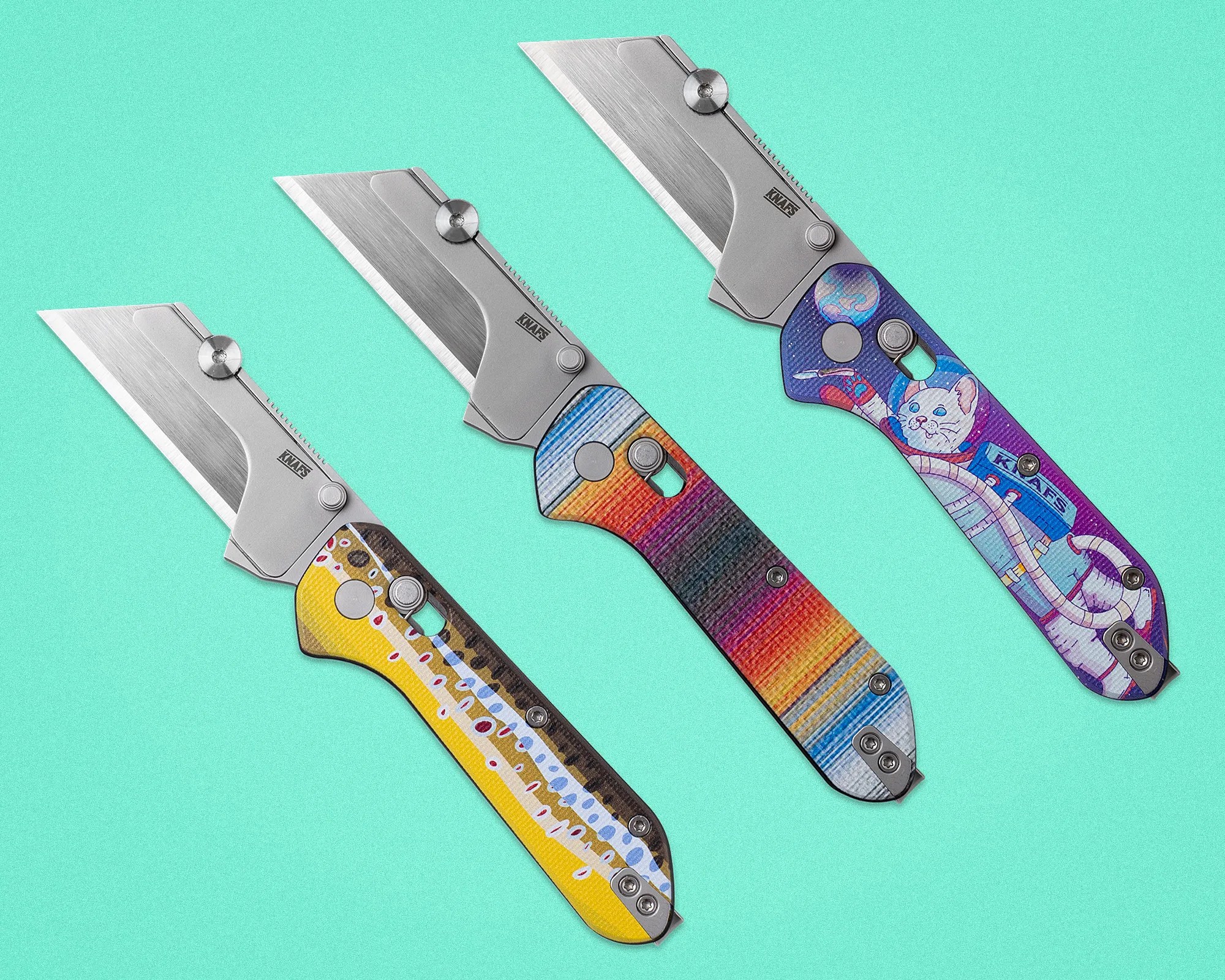 Three folding utility knives with stainless steel blades and colorful patterned handles on a turquoise background.