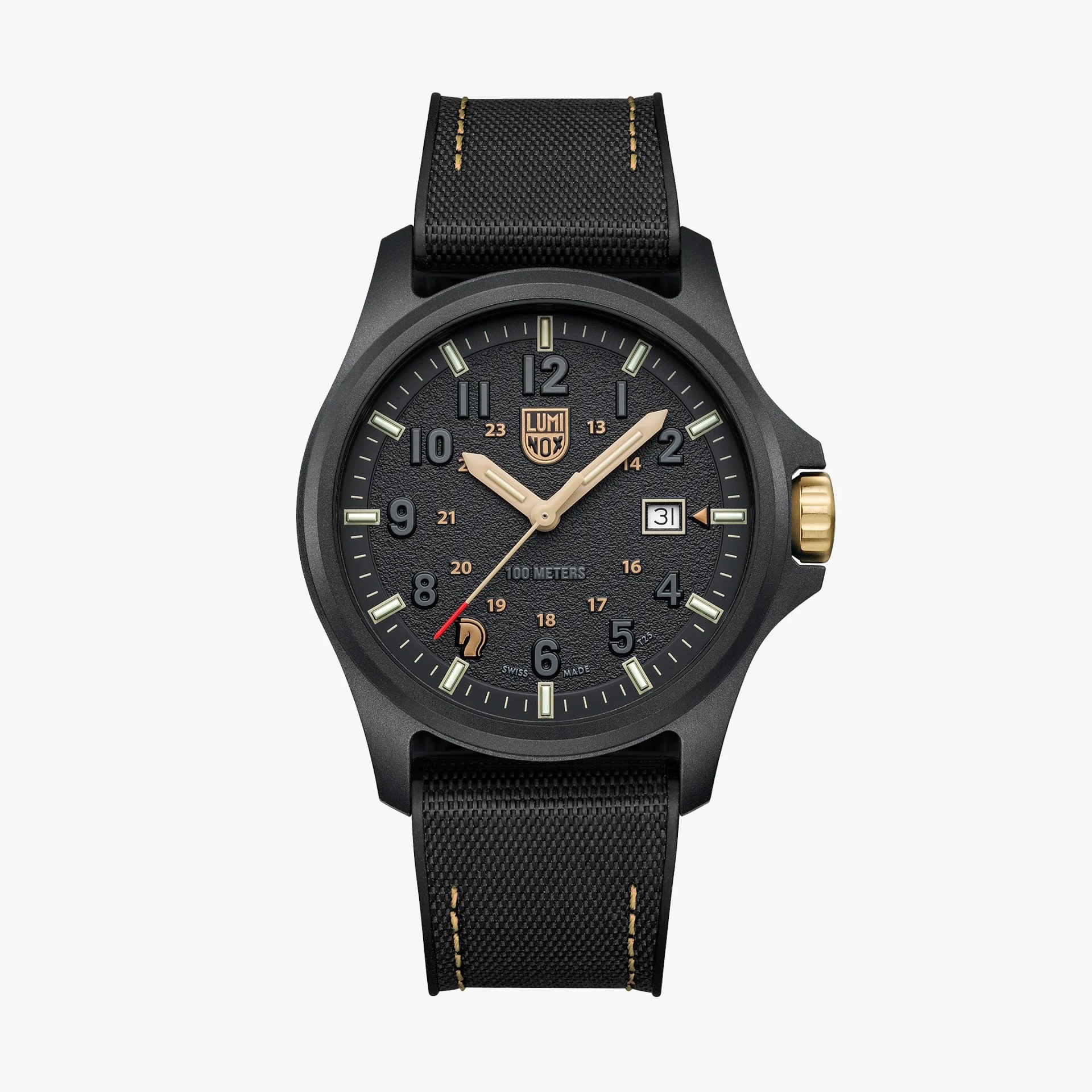Black Luminox wristwatch with textured dial, gold-tone hands and crown, date window, and black fabric strap with tan stitching.