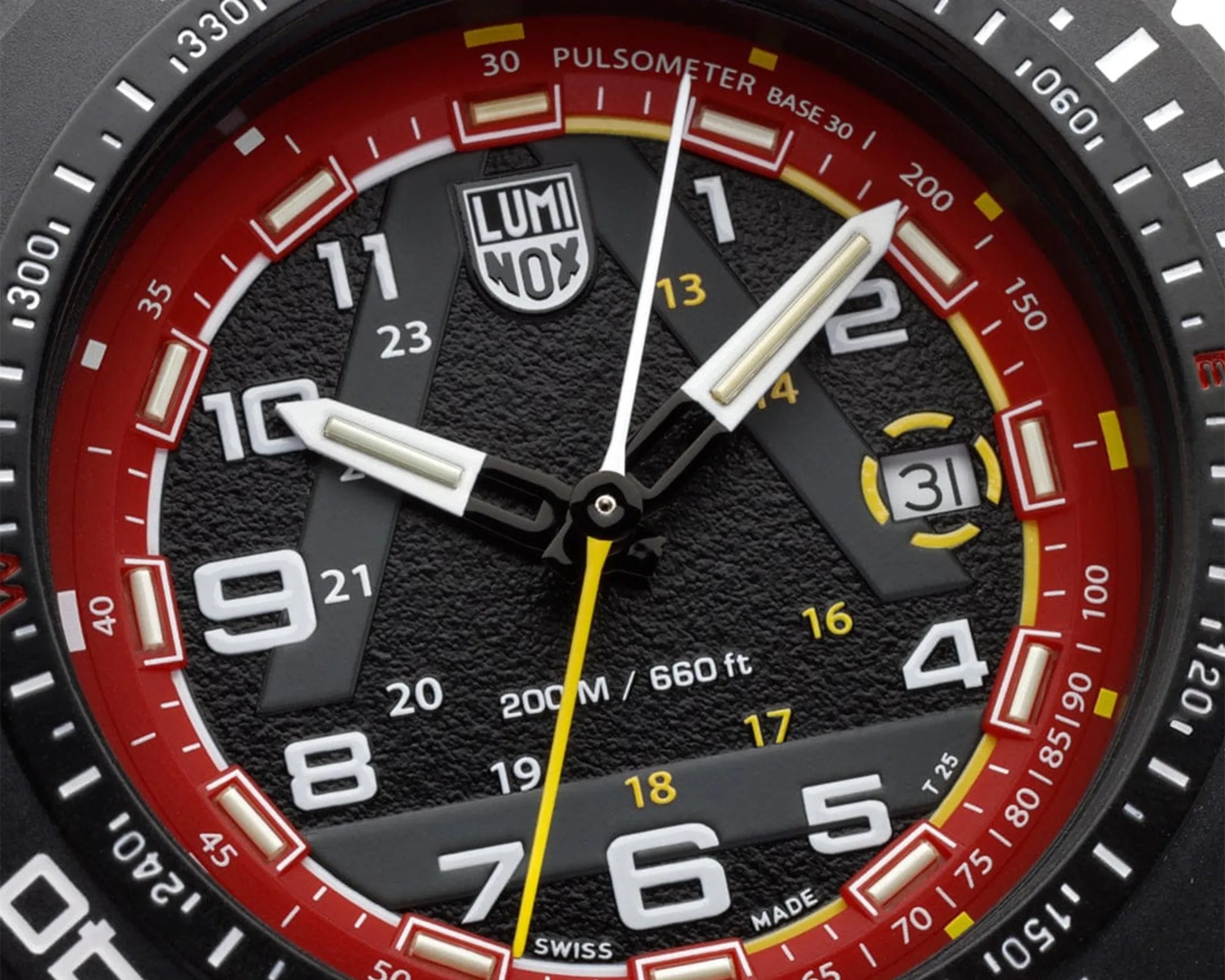 Close-up of a black Luminox watch face with white and yellow numerals, red outer ring, and date display at 3 o'clock.