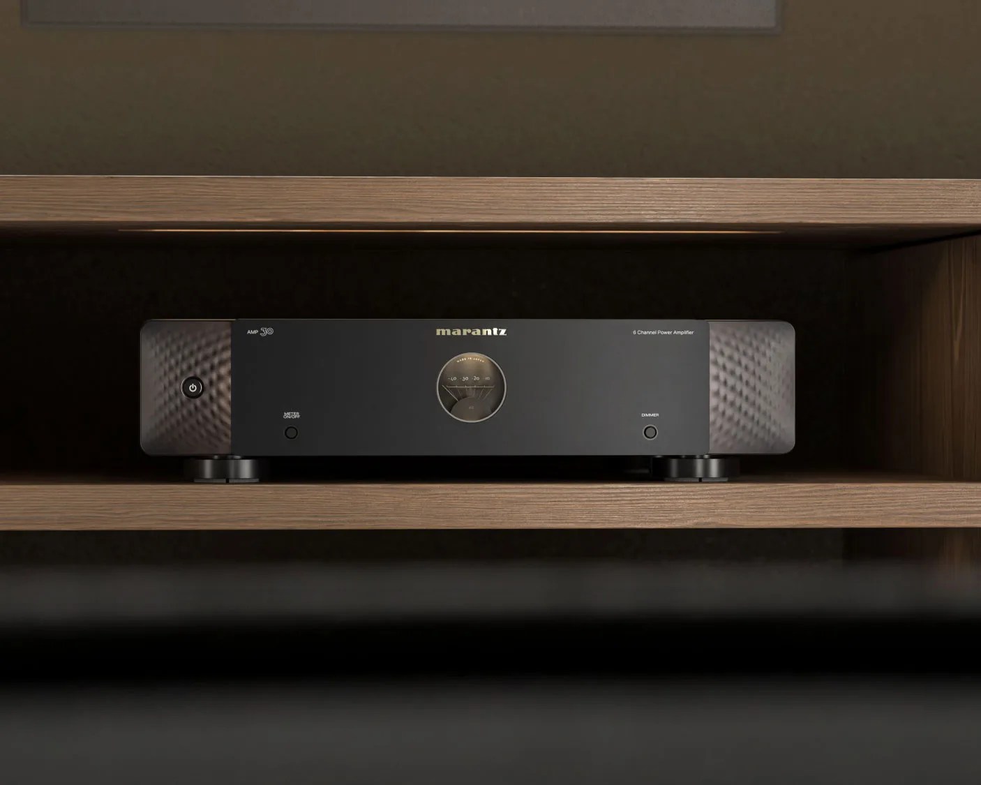 Black Marantz 6-channel power amplifier with analog meter in a wooden shelf.
