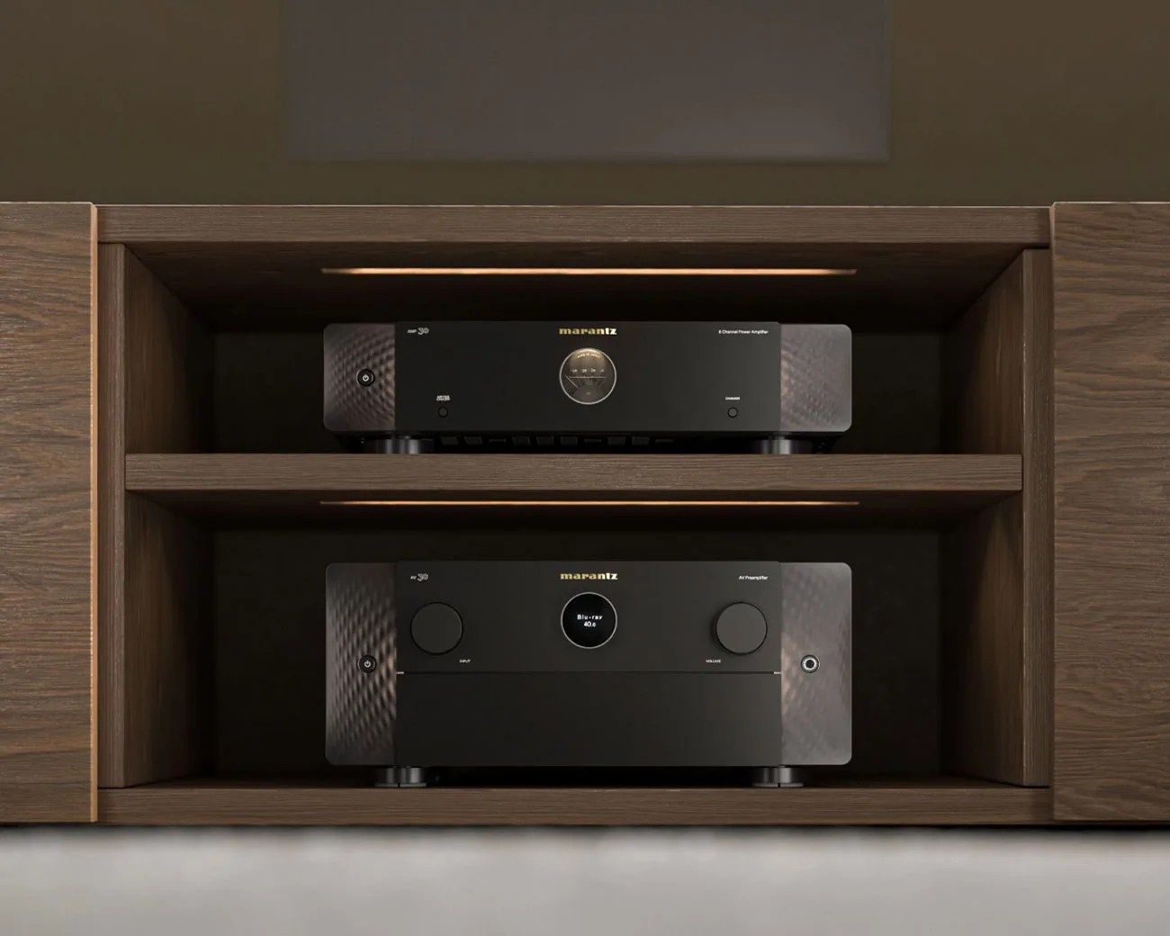 Two black Marantz audio components, an amplifier on the top shelf and a preamplifier on the bottom shelf, housed in a wooden cabinet with built-in lighting.