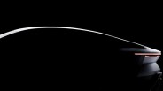 Rear side view of a sleek, futuristic car with illuminated horizontal taillights against a black background.