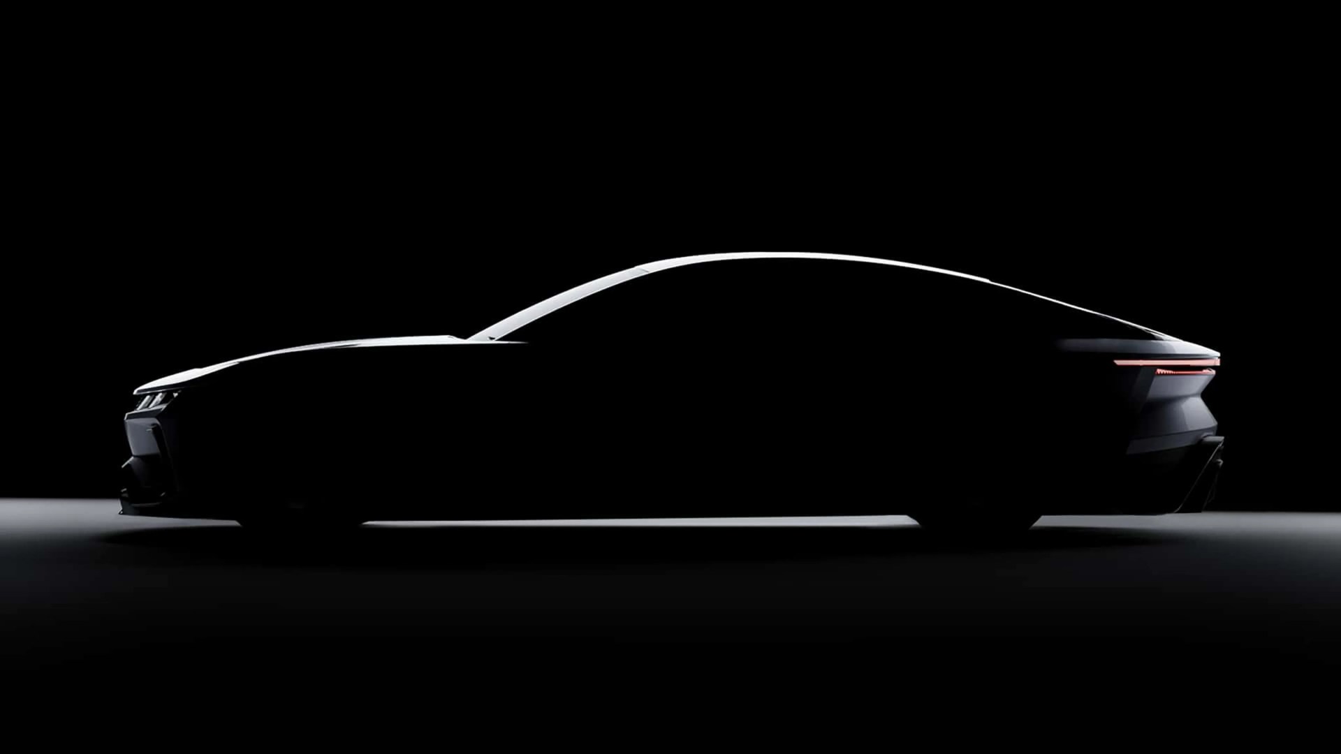 Sleek black car silhouette with illuminated rear light strip against a dark background.