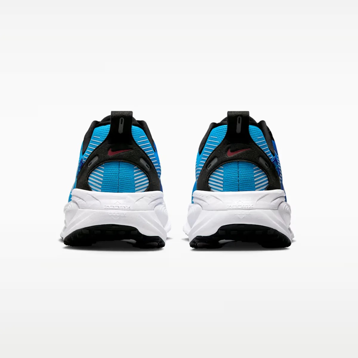 Pair of blue and black Nike running shoes with white soles shown from the back.