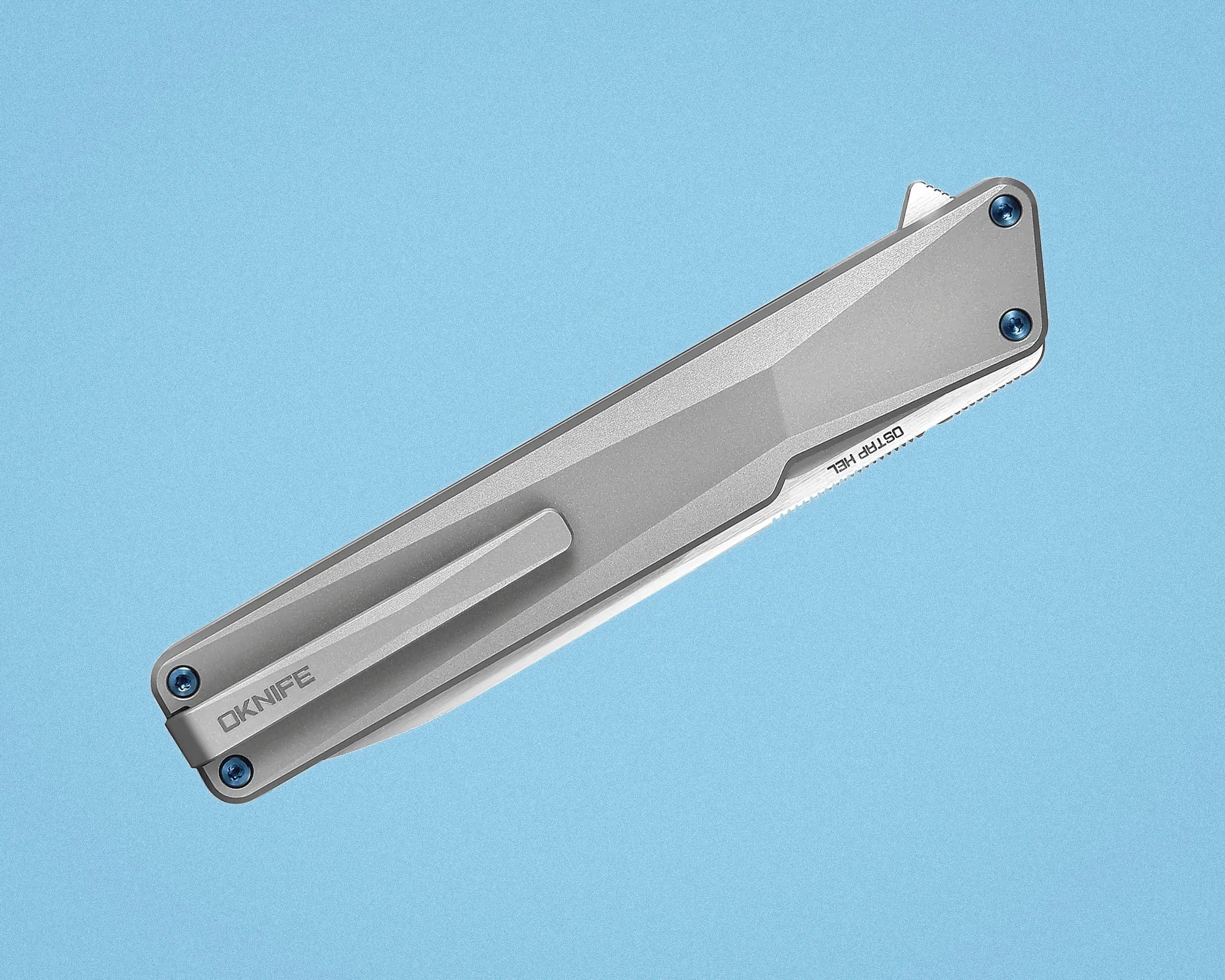 Closed silver folding knife with blue screws and a clip on a light blue background.