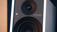 Close-up of a black and white GLX-30 ARC powered speaker with illuminated power indicator light.
