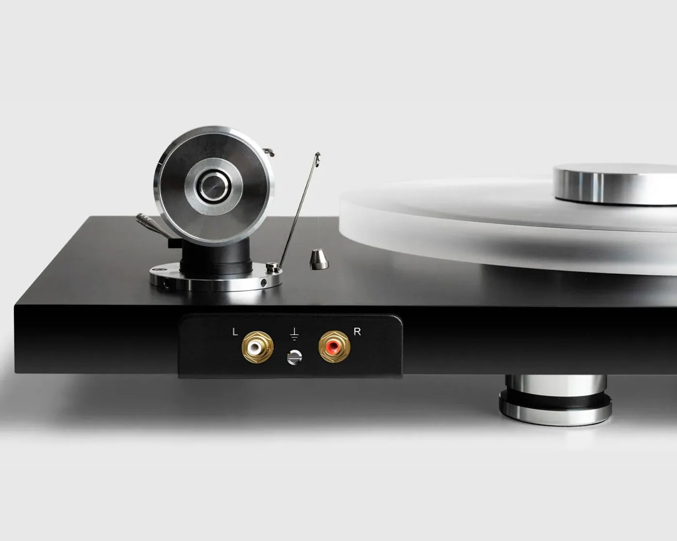 Black and silver turntable with frosted platter and gold-plated RCA audio output connectors.