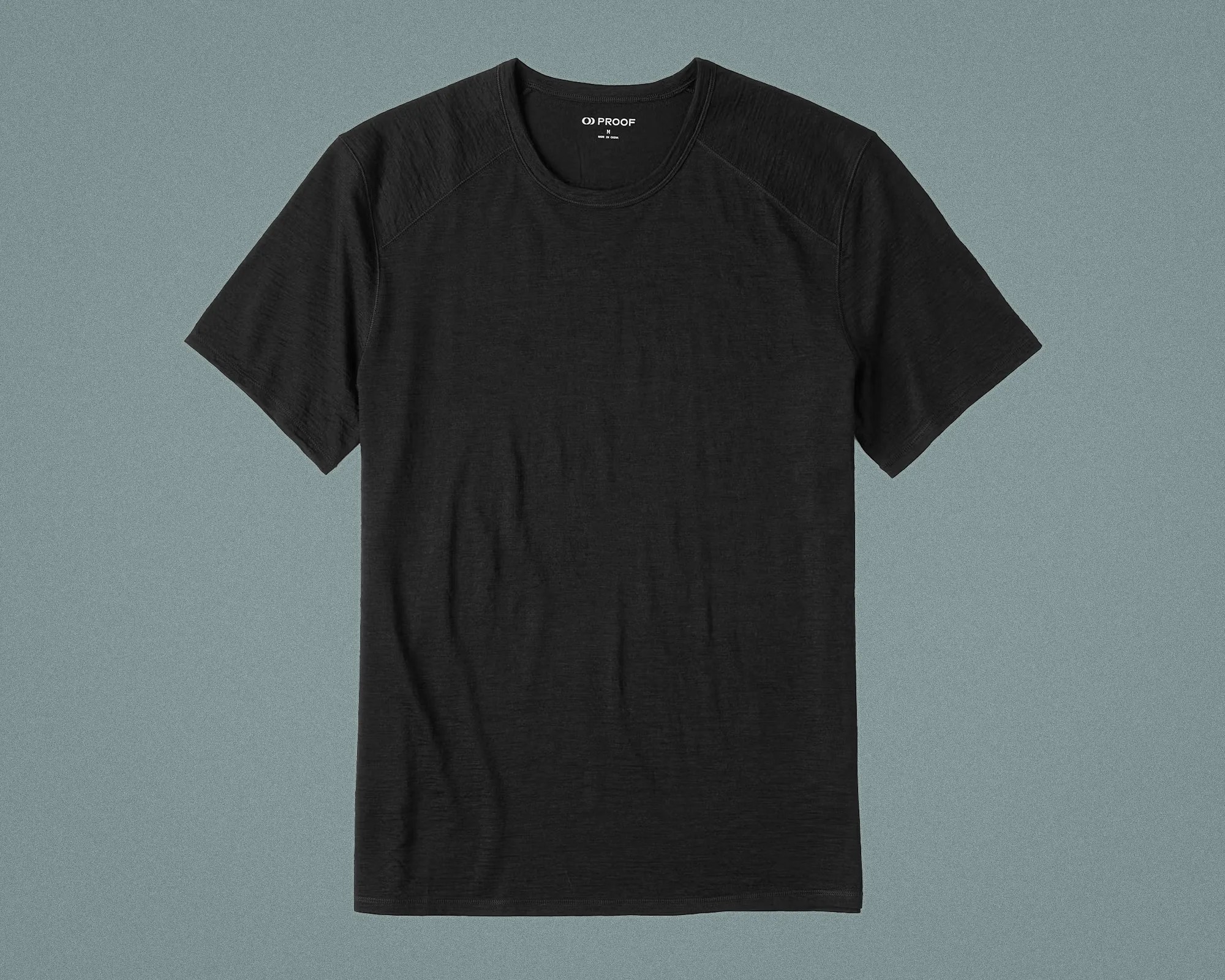 Black short-sleeve crew neck t-shirt with subtle texture laid flat on a gray background.