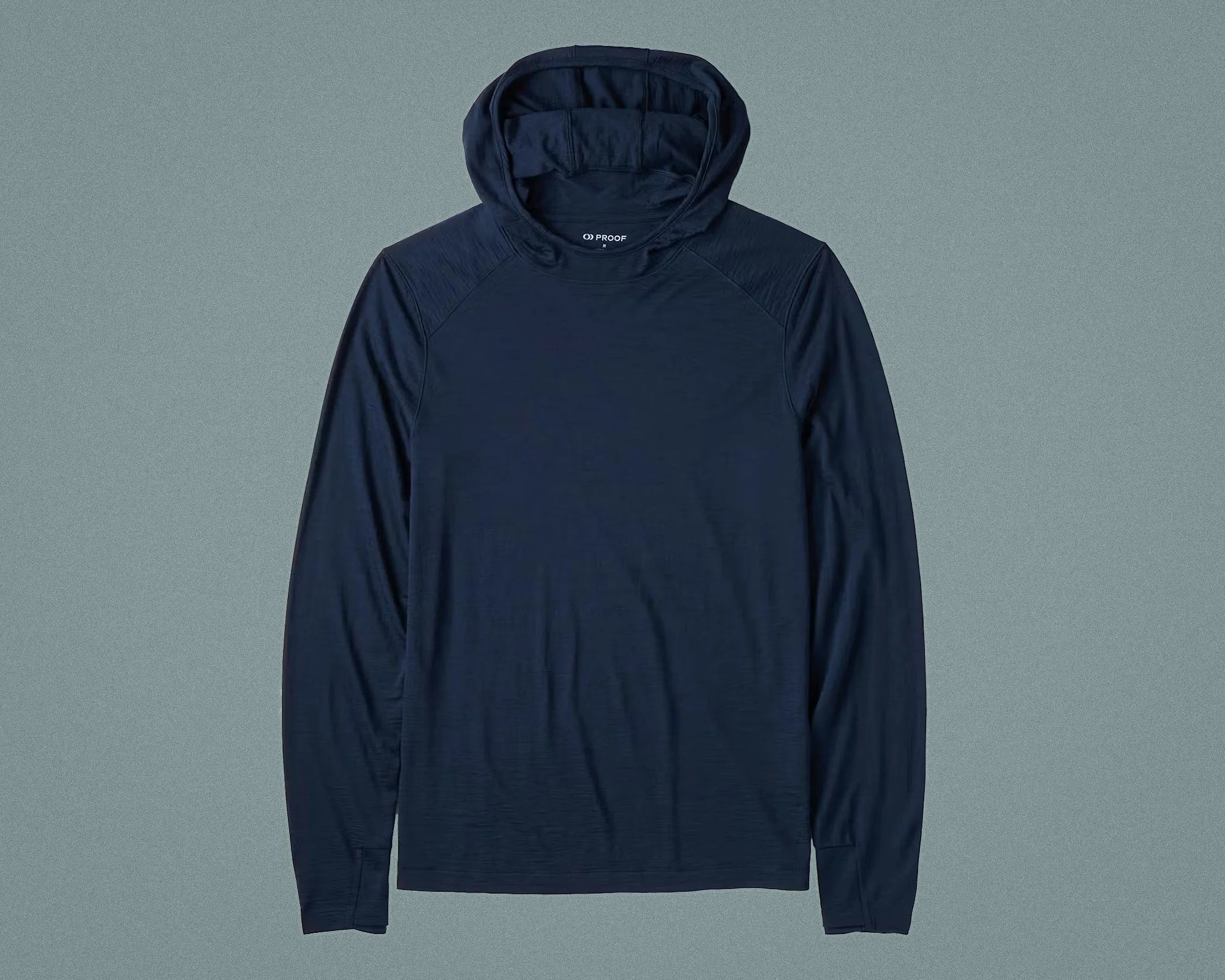 Navy blue long-sleeve hooded shirt with raglan sleeves laid flat on a gray surface.