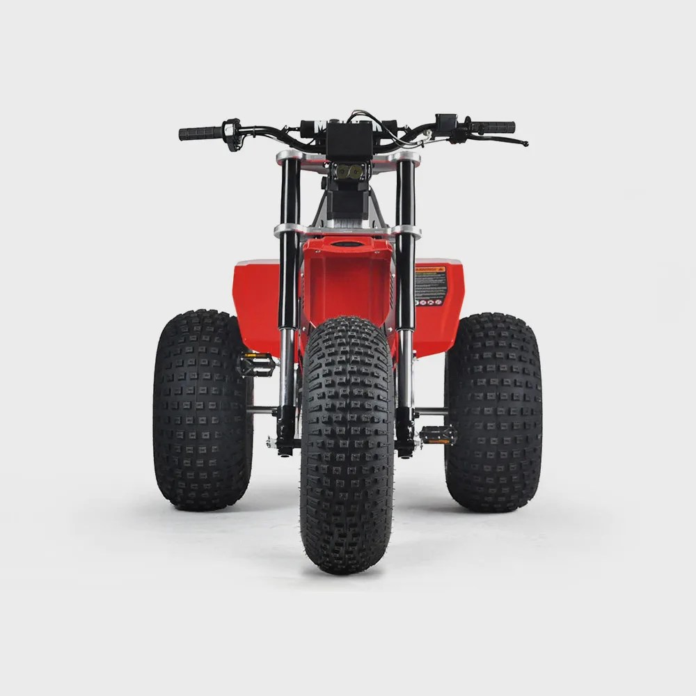 Red three-wheeled ATV with large knobby tires and black handlebars on a white background.