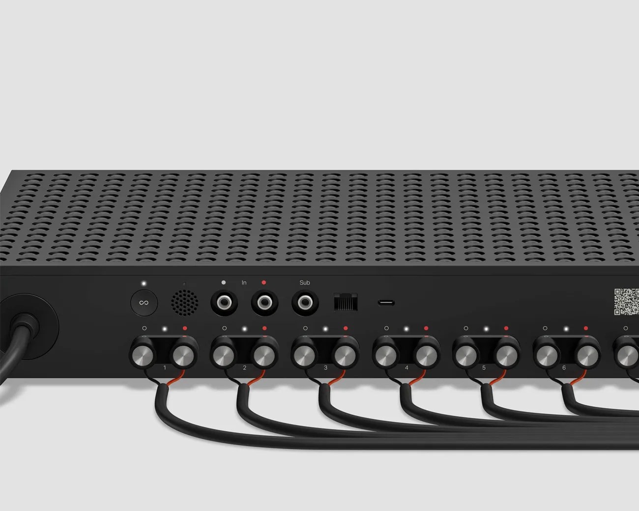 Rear view of a black audio device with multiple speaker wire terminals, RCA inputs labeled In and Sub, an Ethernet port, and a USB-C port.