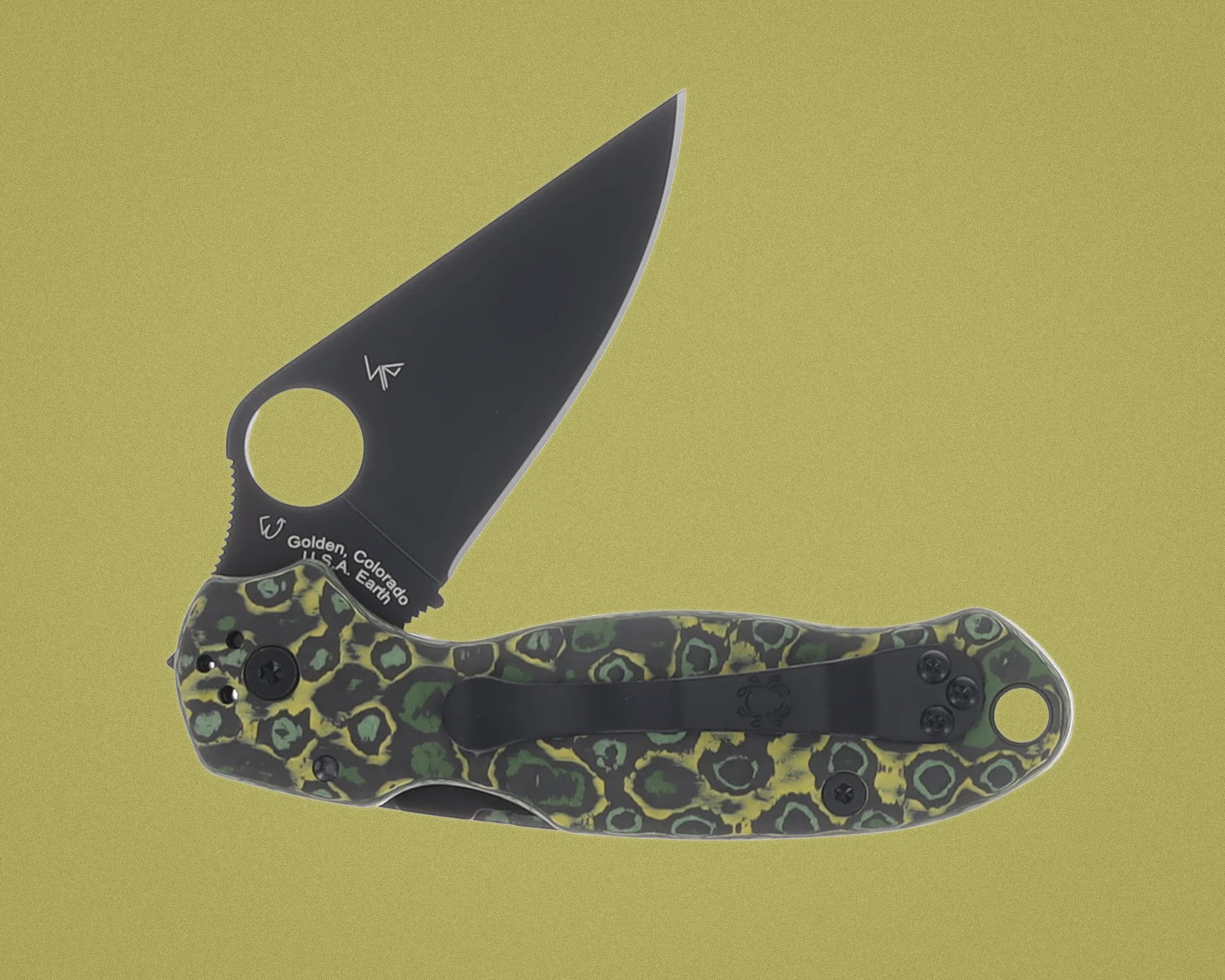 Folding knife with black blade and green-yellow patterned handle featuring a black pocket clip.