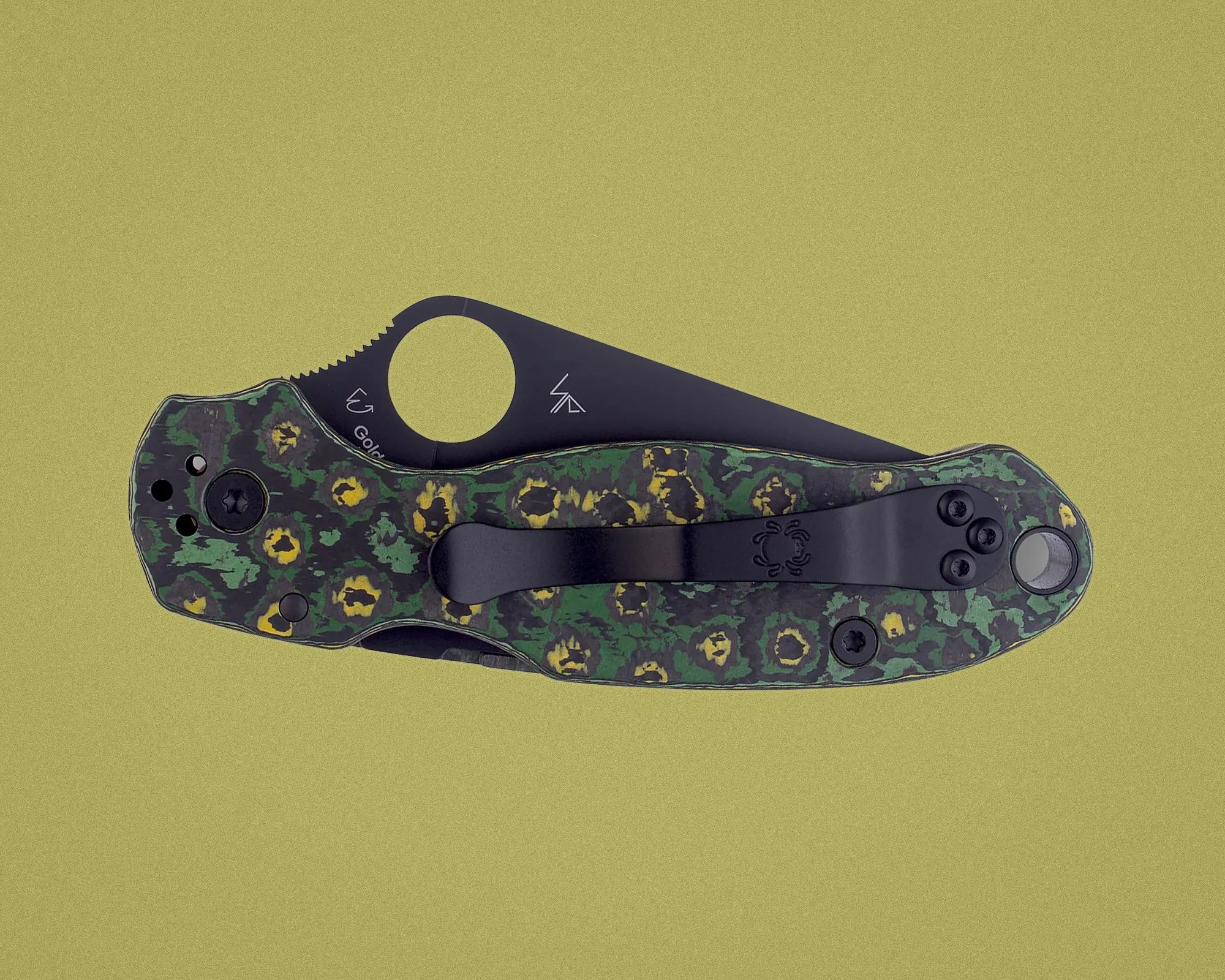 Folded pocket knife with a black blade and a green and yellow patterned handle with a black clip.