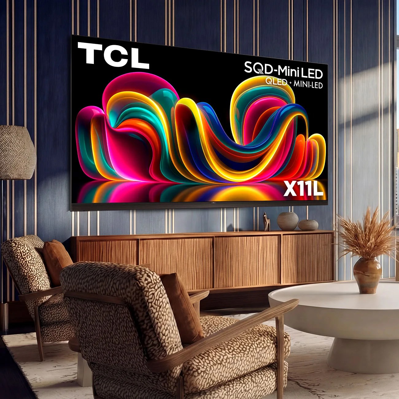 Large TCL X11L QLED Mini-LED TV mounted on a blue striped wall above a wooden cabinet in a modern living room.