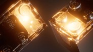 Two transparent LEGO bricks glowing with warm yellow light against a dark background.