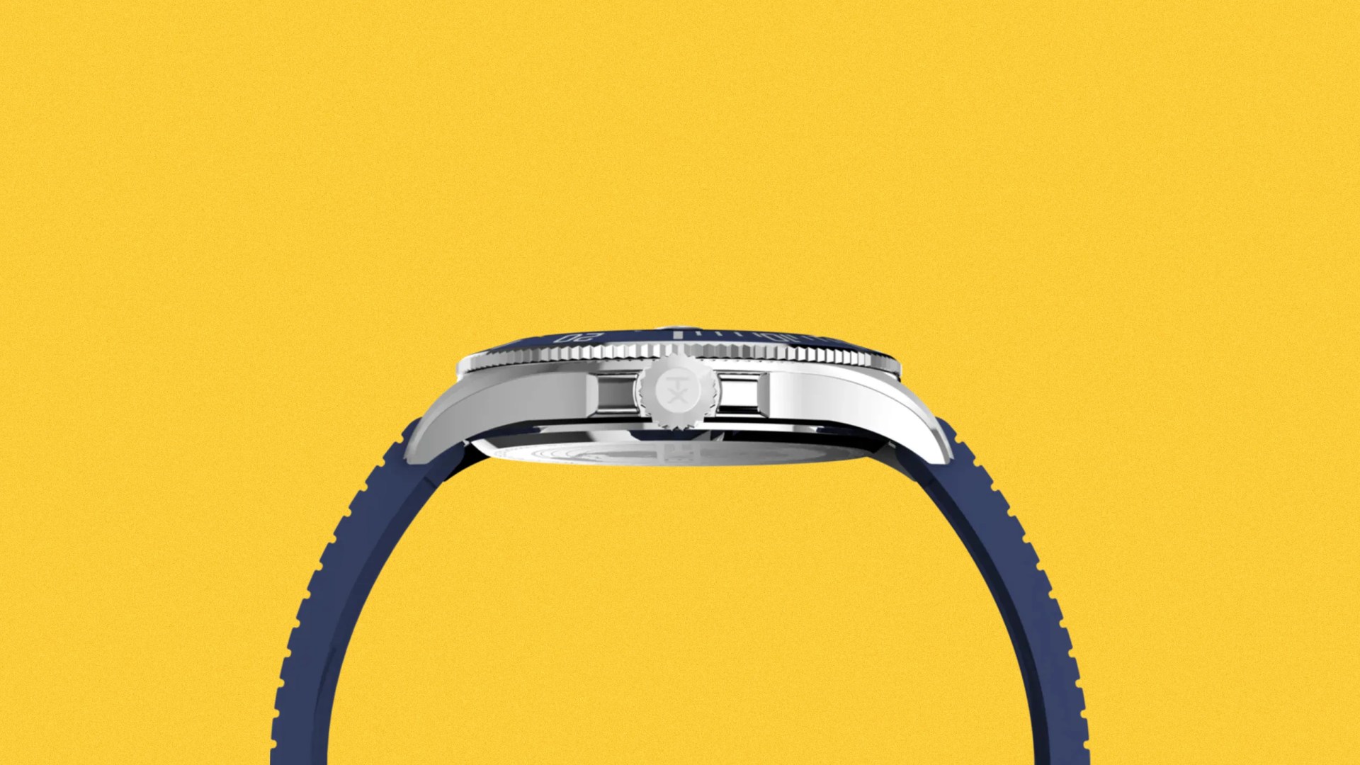 Side view of a silver watch case with a blue bezel and blue rubber strap against a yellow background.