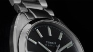 Close-up of a Timex Marlin watch with a black dial and silver metal bracelet.