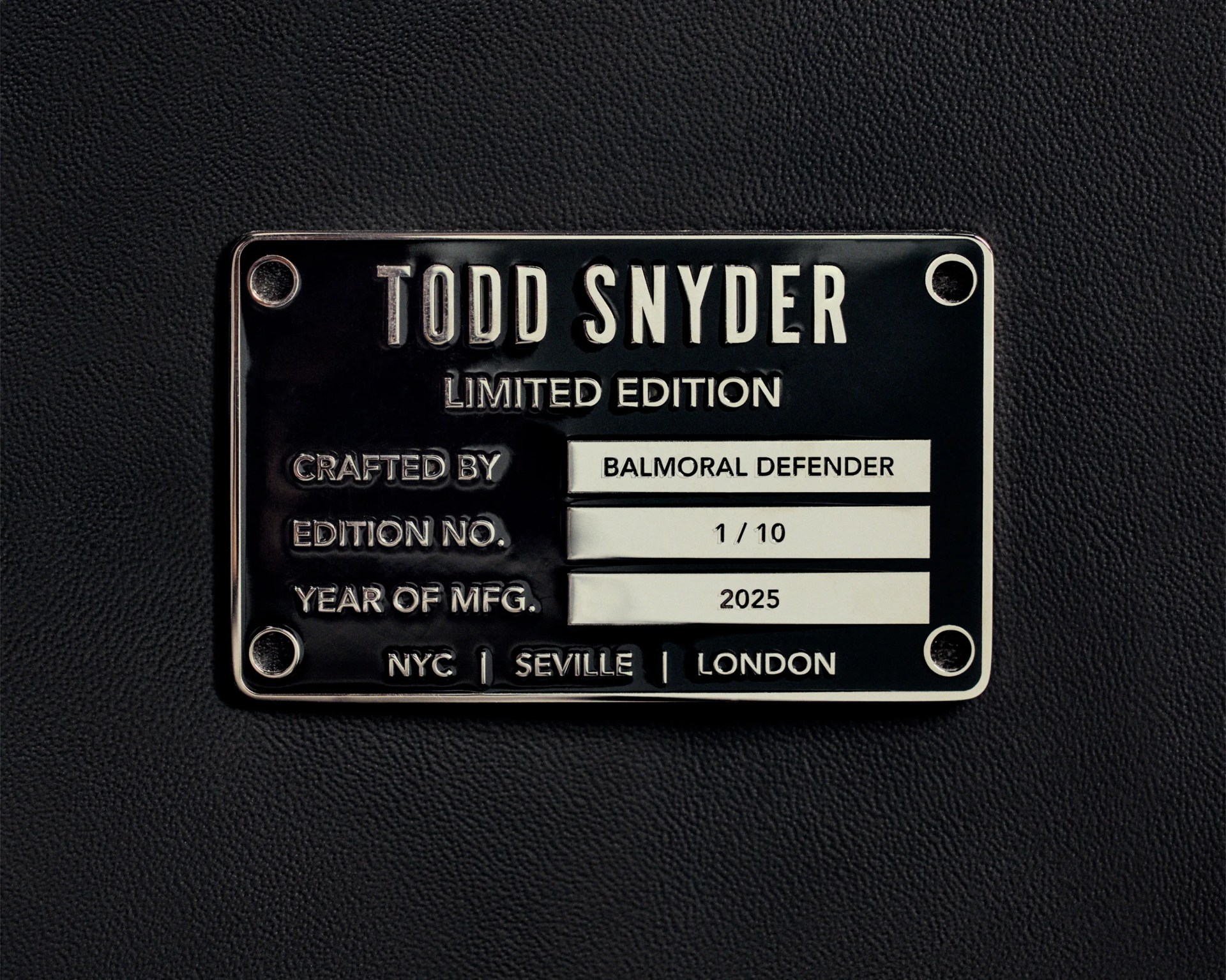 Black and silver metal plaque with "Todd Snyder Limited Edition" and details "Crafted by Balmoral Defender, Edition No. 1/10, Year of MFG. 2025" on textured black surface.