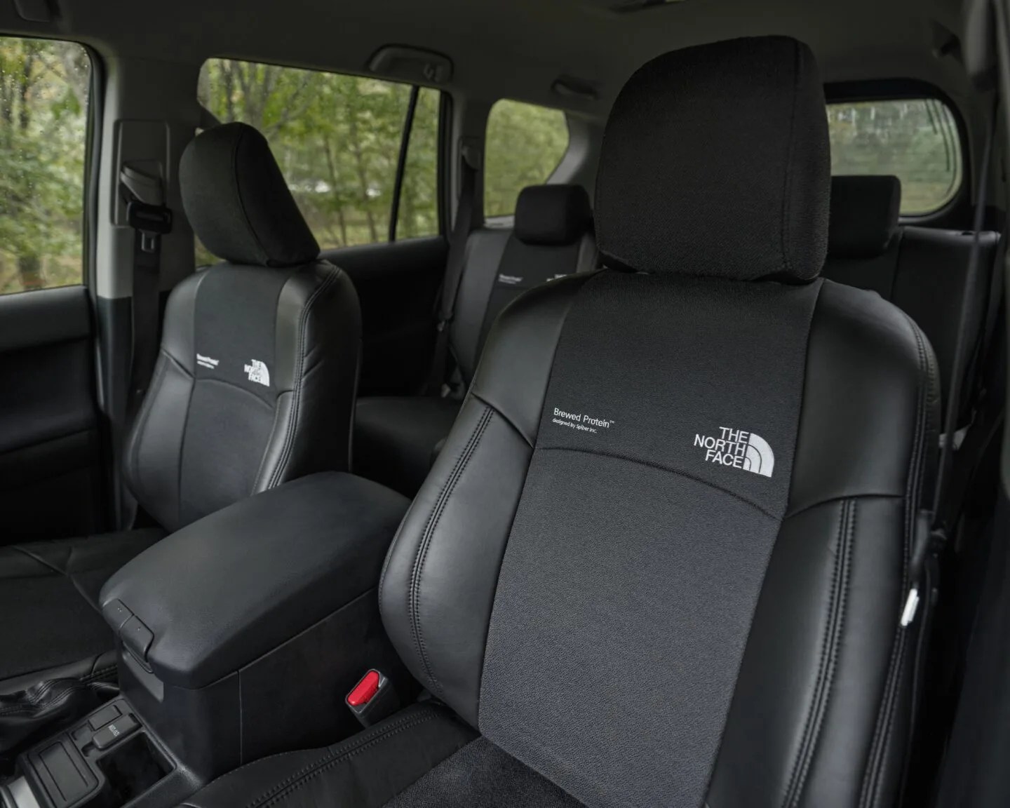 Black and dark gray car seats with The North Face logos embroidered on the backrests.