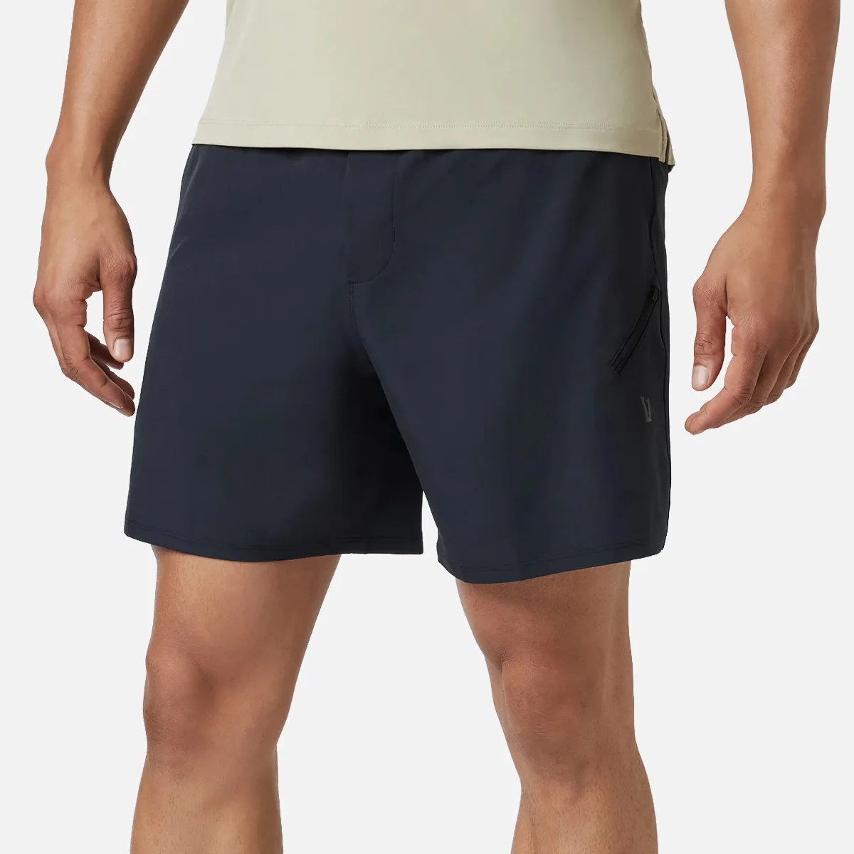 Black athletic shorts with a zippered side pocket worn by a person.