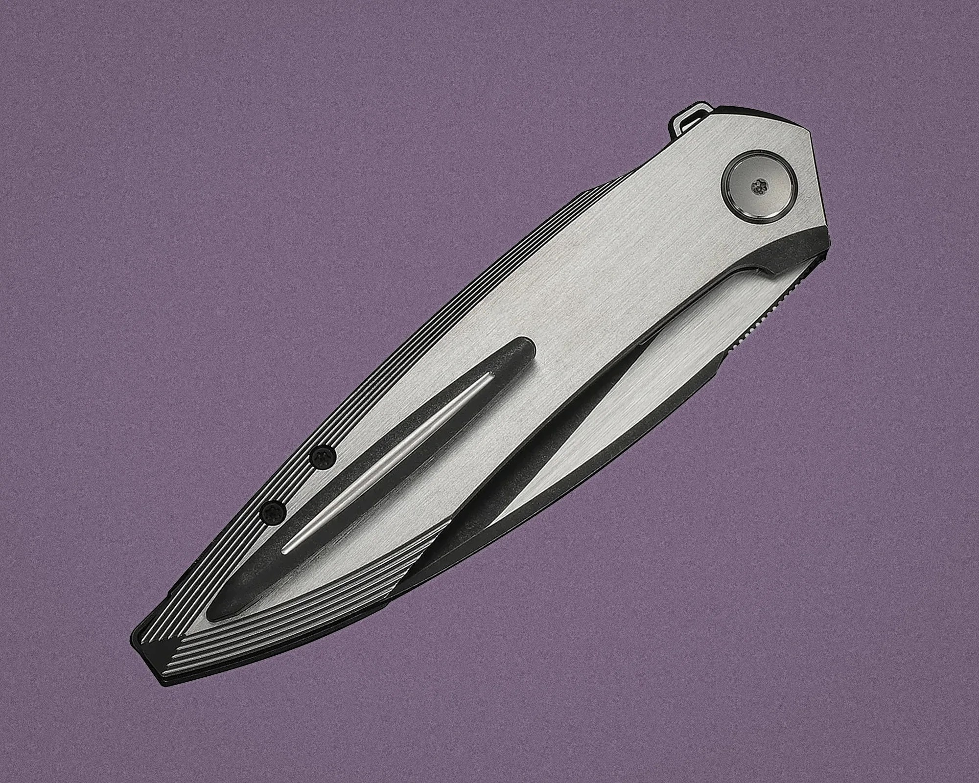 Folded silver and black pocket knife with a clip on a purple background.