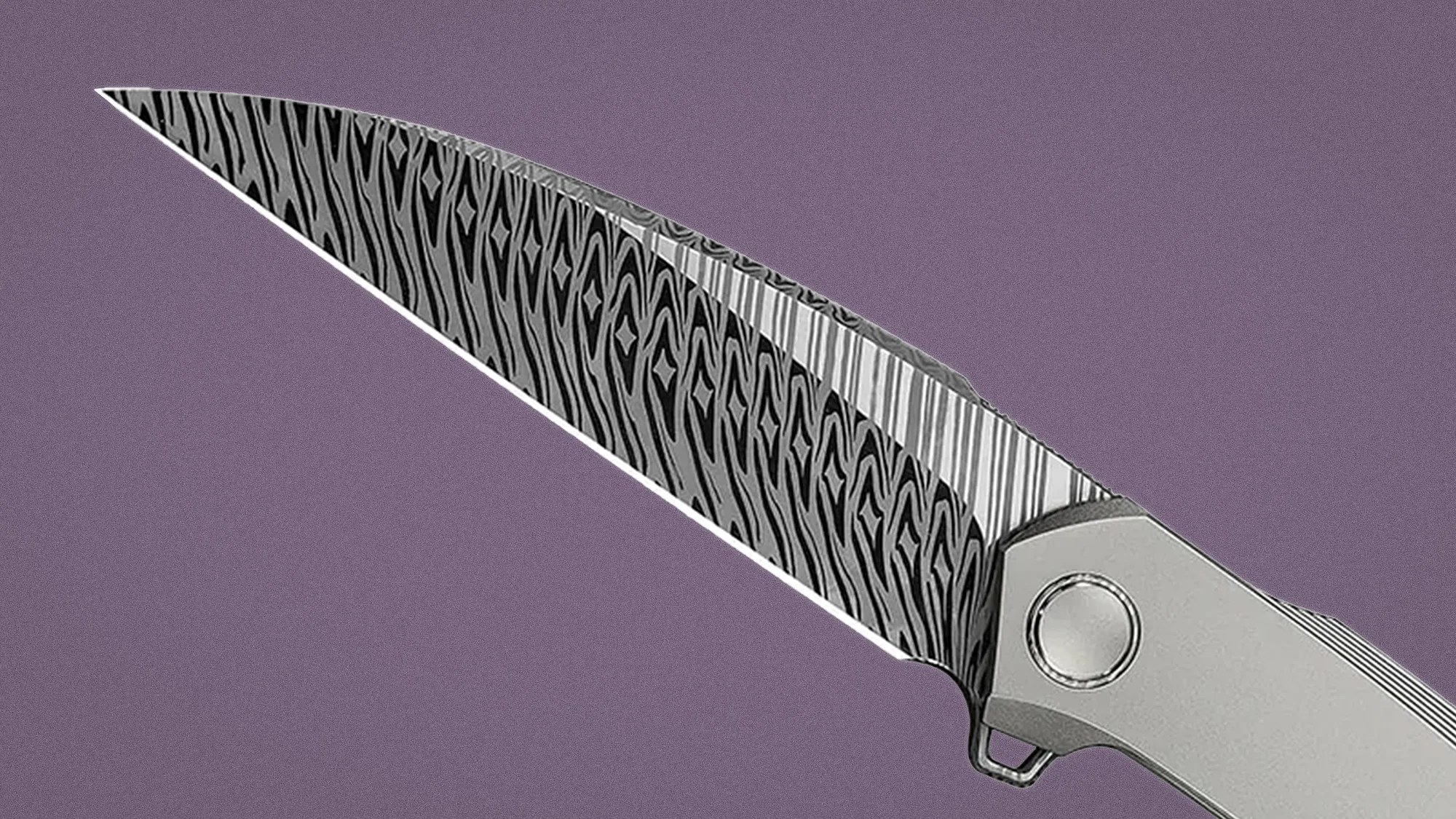 Folding knife with a patterned Damascus steel blade and a silver handle against a purple background.