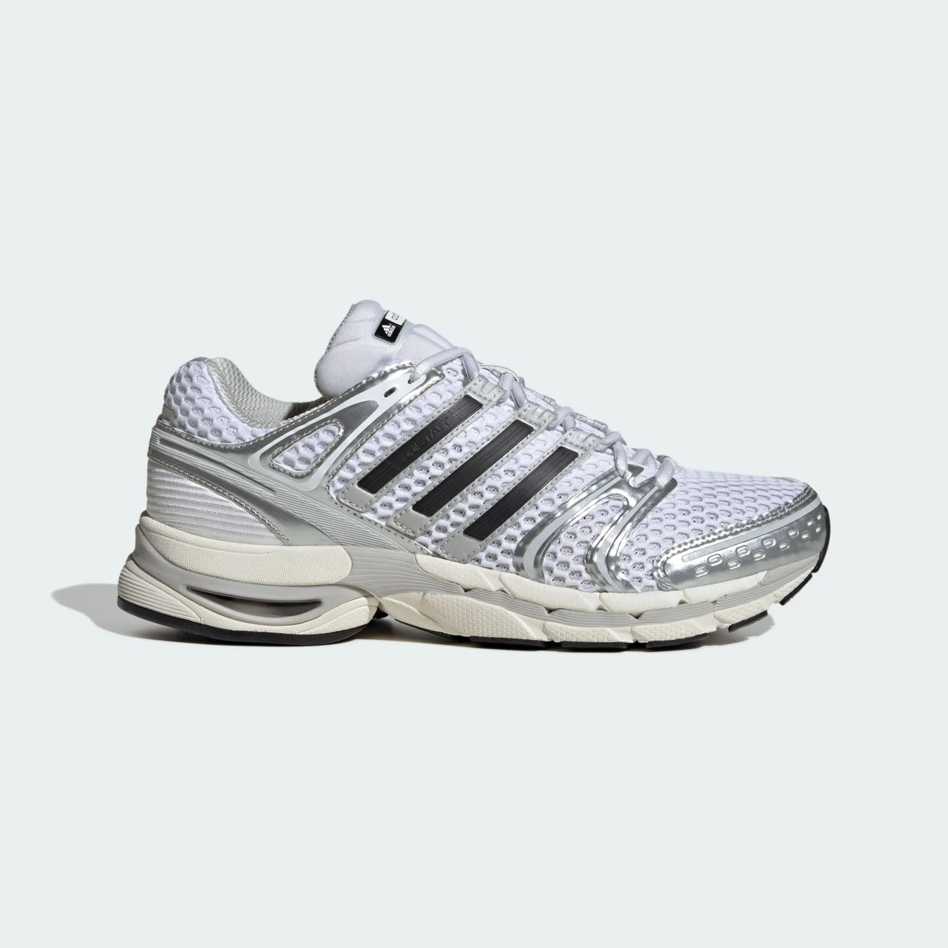 White and silver Adidas running shoe with black stripes and mesh upper, shown from the side.