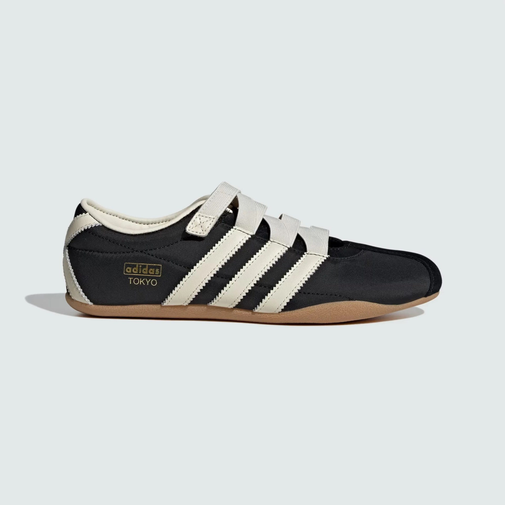 Black and white Adidas Tokyo sneaker with three white stripes and gum sole.